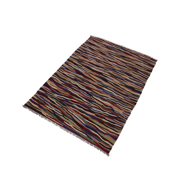 Add a touch of elegance to your home with this casual chic hand woven Tribal Kilim wool rug. Constructed on a loom by...