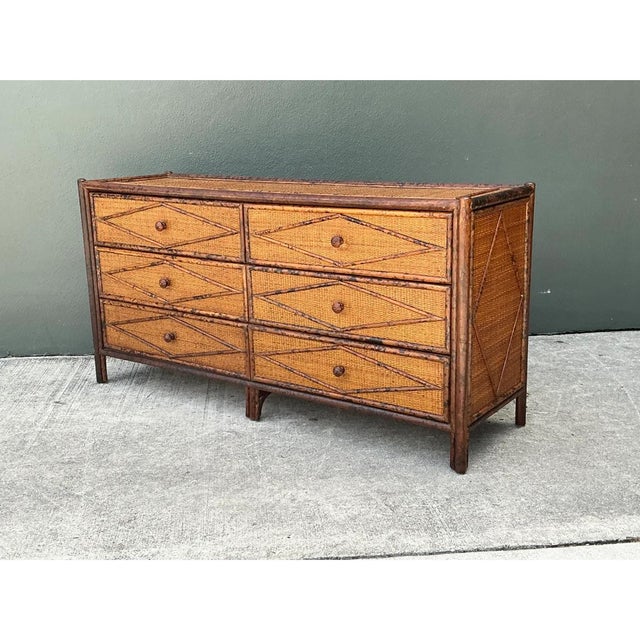 Exuding refined tropical sophistication, this mid-20th-century six-drawer dresser features an elongated, low-profile...