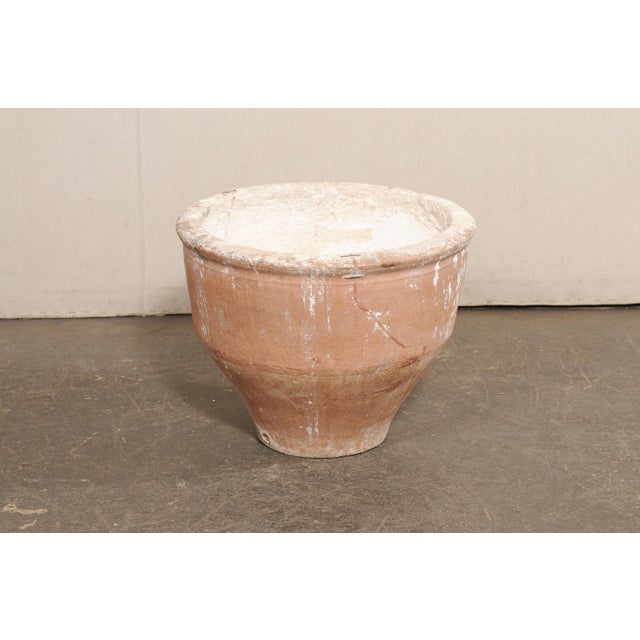 A Spanish terracotta planter from the 19th century. This antique planter from Spain, approximately 2 feet in height, has a...