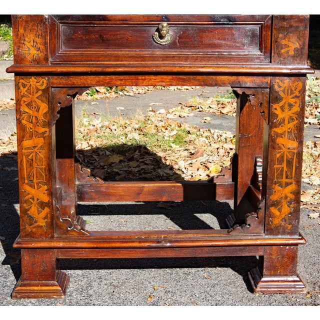 A substantial rustic Italian baroque one drawer table with marquetry. Solid walnut with very unusual marquetry. The table...