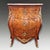 A fine antique Italian Venetian serpentine commode dating to circa 1810, constructed in walnut and richly embellished with...