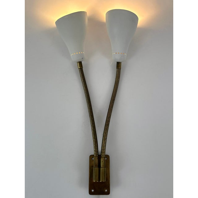 Rare, lovely and highly decorative mid-century modern sconce or wall lamp with two adjustable / gooseneck arms. Designed...