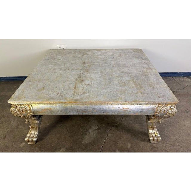 A striking Italian silvered wood coffee table, crafted in the early 20th century and richly detailed in the Baroque...