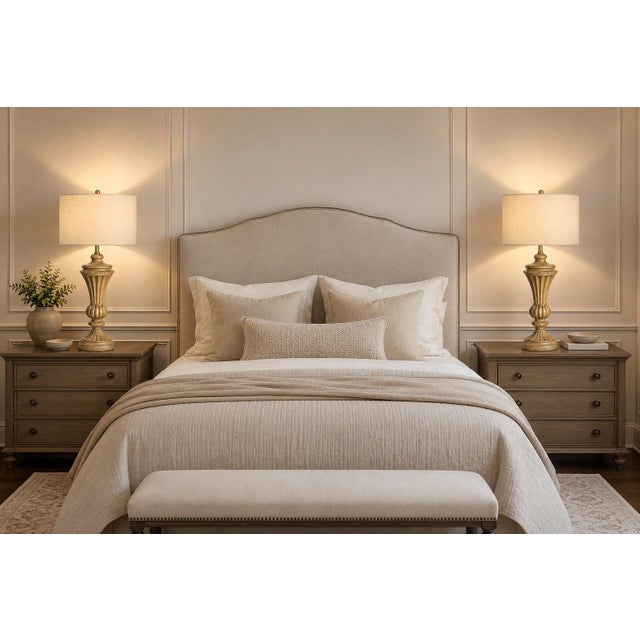 A handsome matching pair of vintage neoclassical table lamps featuring tall, sculptural urn-form bodies and a beautifully...