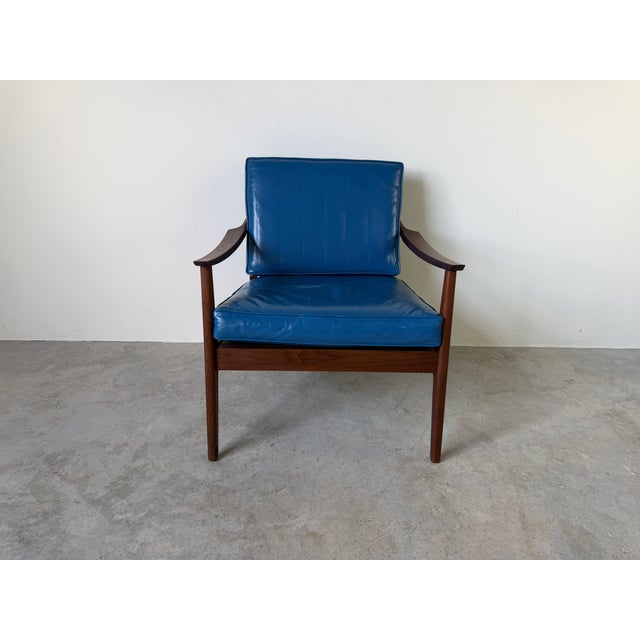A beautifully crafted lounge chair designed in the style of Ib Kofod Larsen. Featuring a solid teak frame with gracefully...