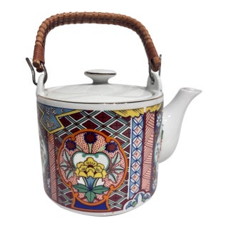 Vintage Japanese Imari Ware Porcelain Teapot Featuring a Woven Bamboo Handle and Colorful Geometric Floral Panels. For Sale