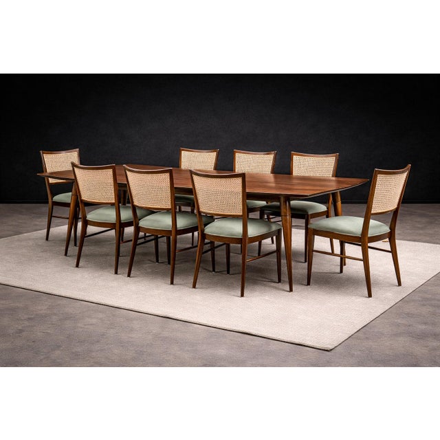 An elegant Brazilian modernist dining table attributed to Giuseppe Scapinelli, crafted in richly figured caviúna wood,...