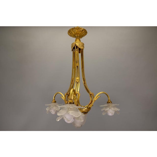 Antique, elegant early 20th-century French chandelier with refined neoclassical lines and softly diffused glass light. A...