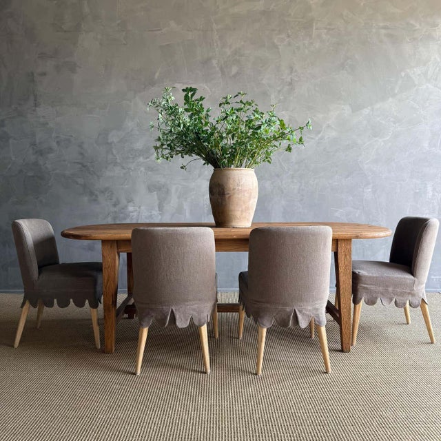 This reclaimed pine dining table exudes antique charm with its solid and sturdy construction. The warm honey tone of the...