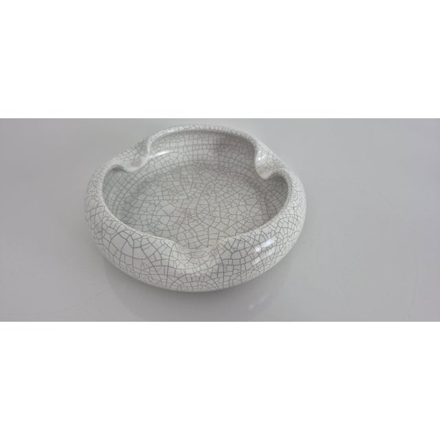 Large crackle-effect ceramic ashtray by Silberdistel from the 1970s. Marked 673/20 on the underside. This piece has an...