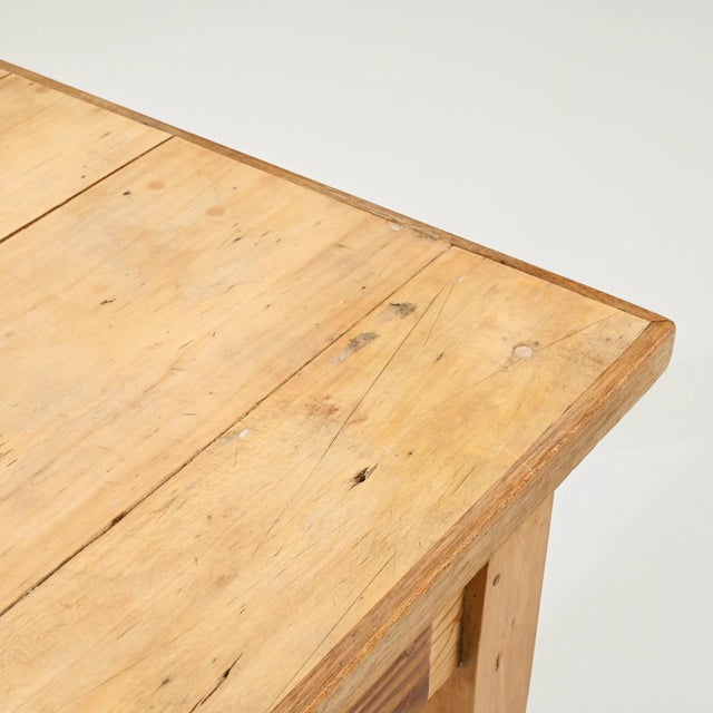 A wooden table created in 1900s France. Minimal and sturdily constructed, this table exudes a sense of forthright purpose...