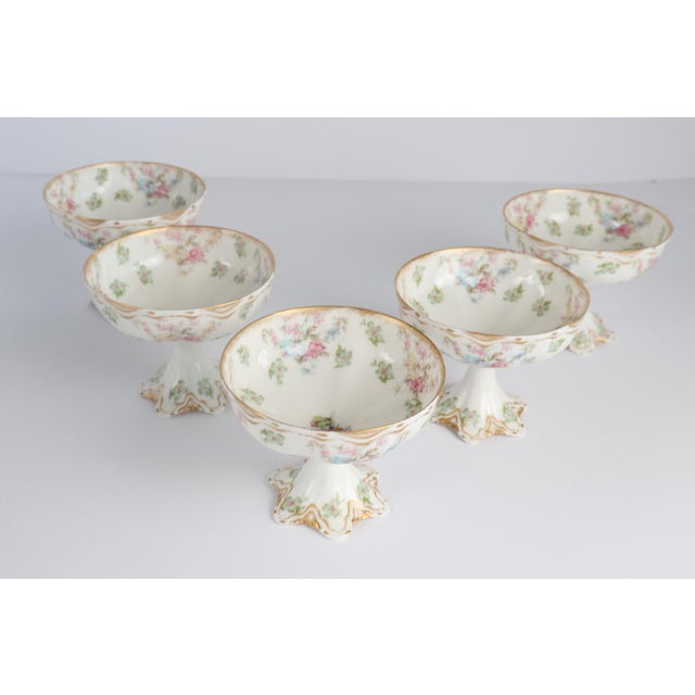 A charming set of five antique Haviland & Co. Limoges France footed dessert cups, delicately hand-decorated with soft...