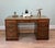 Handsome English Victorian pedestal desk crafted from mahogany Rectangular top inset with a green tooled leather writing...