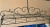 Custom made wrought iron hanging kitchen pot rack with scrolled top, base with interspersed ironwork in x cross and...