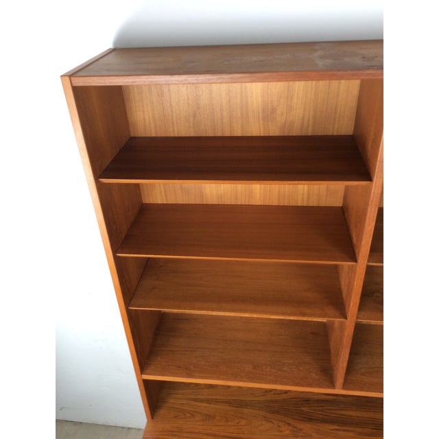 This Danish Modern shelving unit features pressed wood construction, beautiful teak veneer with original finish, six...