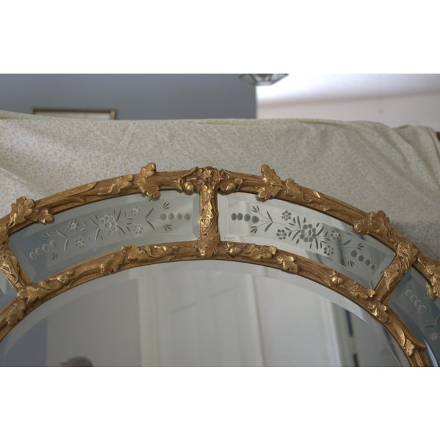 Striking Vintage large oval beveled mirror by Friedman Brothers. Gold acorn and oak leaves surround with individual...