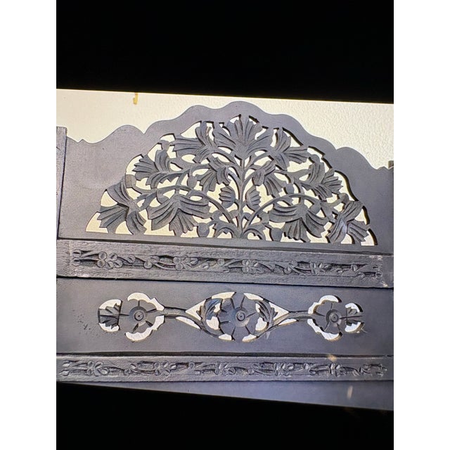 This 3 panel intricately carved, multi-panel wooden room divider, often referred o as a folding screen or partitian. It is...