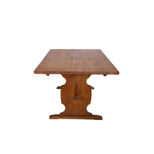 Timeless Scandinavian dining table crafted in solid oak with sculptural trestle-style legs and warm natural patina. A...