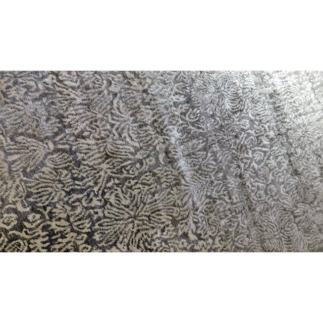 Dense floral pattern emerging to streaking lines in white on silver gray field. Lush bamboo silk texture.
