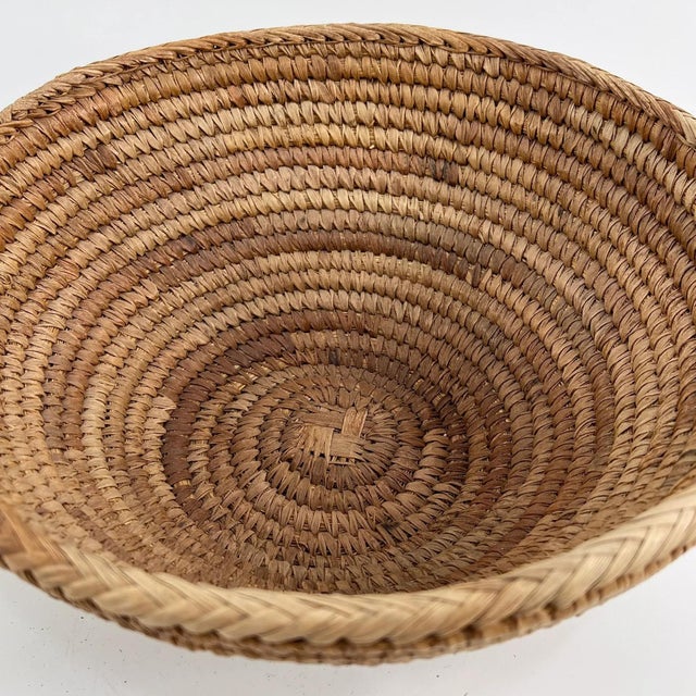 Handwoven basket made by the Tonga people of Zambia. Traditionally crafted from natural plant fibers, these baskets are...
