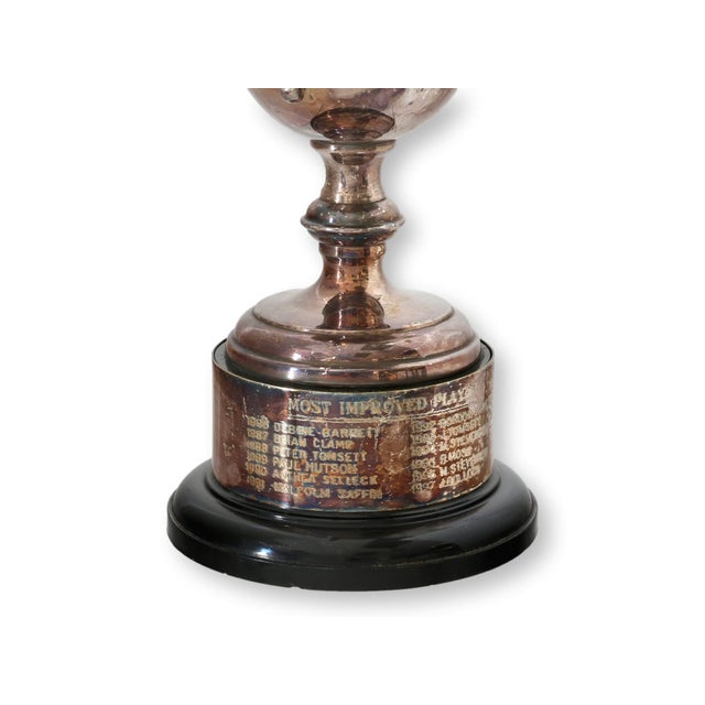 English silverplate sports trophy dated 1986, featuring an elegant twin handled cup raised on a stepped base. The...