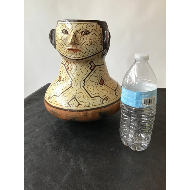Shipibo Peruvian face vase. Hand painted clay .