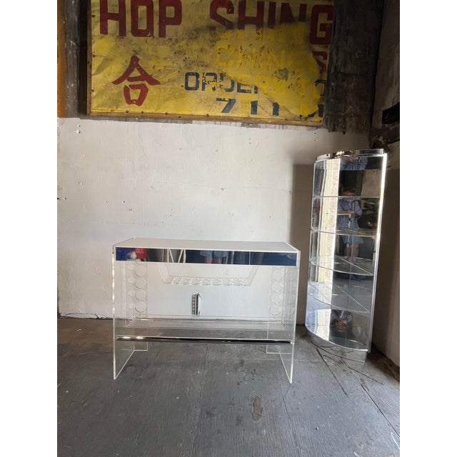 Fabulous mid century lucite bar and corner shelf by Luigi Bardini for Hill Manufacturing. Tubular chrome foot rail and...