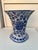 Vintage Chinese blue and white porcelain vase featuring a trumpet shape and floral designs. Features traditional foliage...