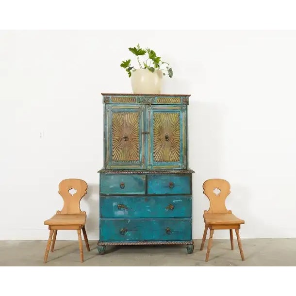 Rustic set of four 19th century primitive country Swedish hand-carved folk art farmhouse chairs crafted from pine. The set...