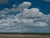 "Gathering Form" is an oil on canvas landscape painting by Michael Magrin, completed in 2026. Cumulus clouds fill the...