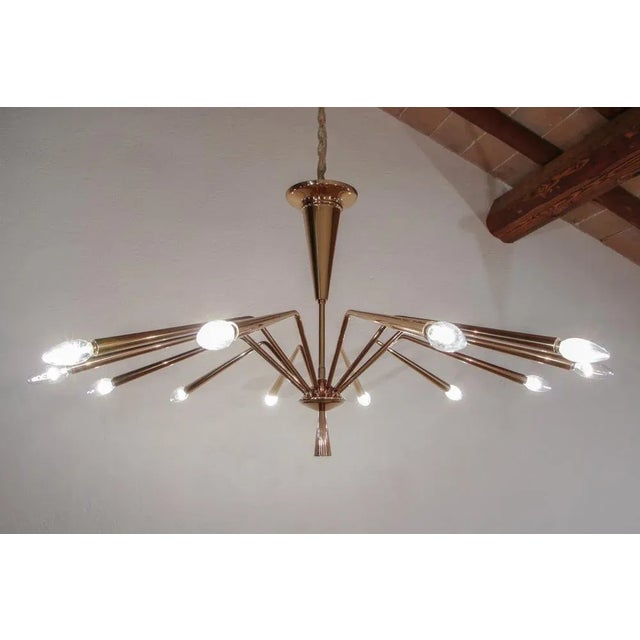 Magnificent mid-century modern Chandelier by Oscar Torlasco for Lumi Milano, model 234, from the 1950s, Italy. The...