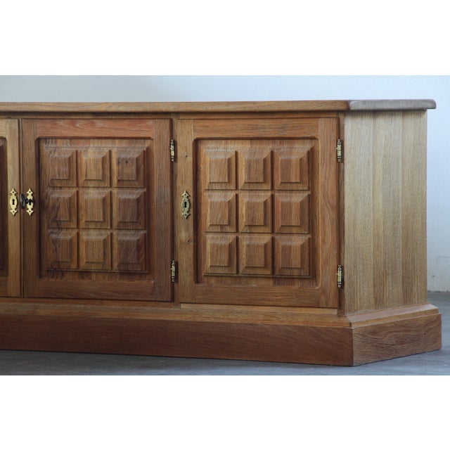 A Danish Mid-Century Modern low sideboard crafted from Nordic oak, designed and manufactured in Denmark during the...