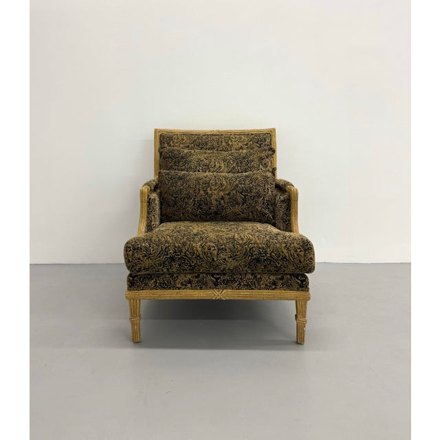Elegant lounge chair featuring a faux bamboo frame with refined Asian-inspired detailing and plush loose cushions...