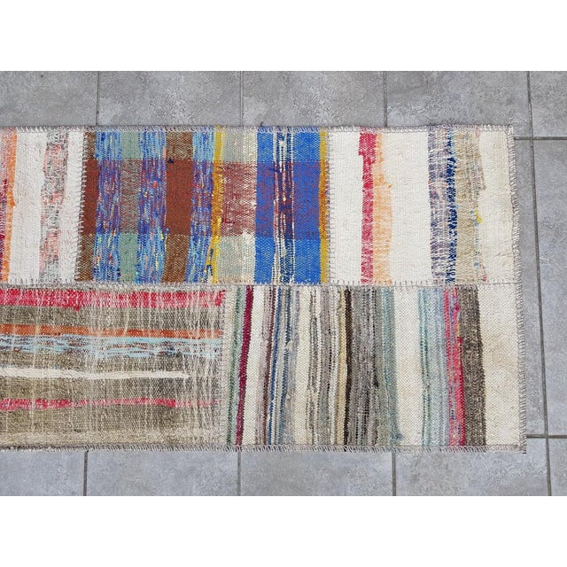 This is a vintage Turkish Oushak rug from the Mid 20th Century. The piece was hand-knotted.