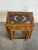 A set of three space-saving nesting tables styled with curved aprons and turned support legs. Each surface features inset...