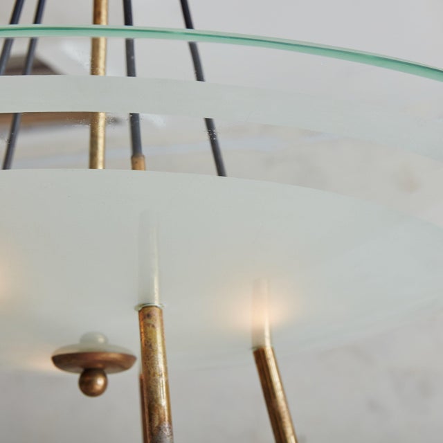 A stunning 1960s Italian pendant light featuring a partially frosted round glass shade with a subtle aqua-hued rim. The...