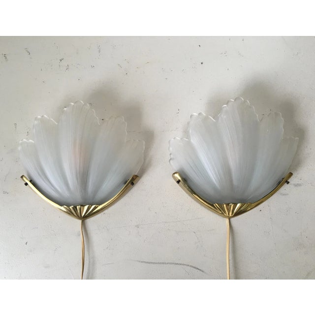 These two large sconces feature a frosted glass shell with a gold colored metal holder. They were manufactured in Europe,...