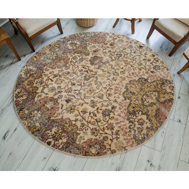 This exceptional circular textile represents a masterclass in restorative reshaping, salvaged from a traditional hand-...