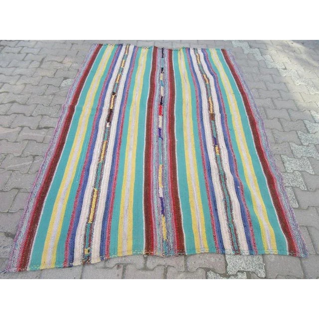 This is a handwoven vintage kilim rug from the Adana region of Turkey. The piece is approximately 40-50 years old.