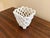 An elegant trompe l'oeil porcelain cachepot crafted in the form of a handwoven rope basket. Executed in glossy white...