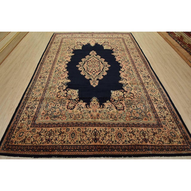 An authentic semi-antique traditional Sarouk rug hand-knotted with fine wool and natural dyes. This oriental rug features...
