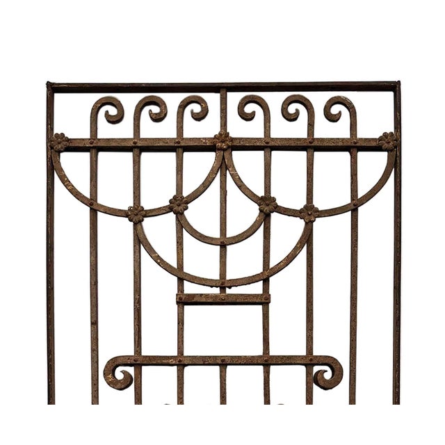 Antique Italian wrought iron decorative panel featuring repeating scrolls, "S" curves, and central heart-shaped filigree....