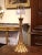 Hand carved in France circa 1960, the antique lamp base features a cone shape with spline decor, and adorns a beautiful...