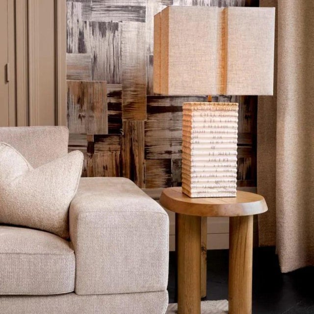 Oak side table with a natural finish and distinctive free-form silhouette. The solid wood construction highlights the...