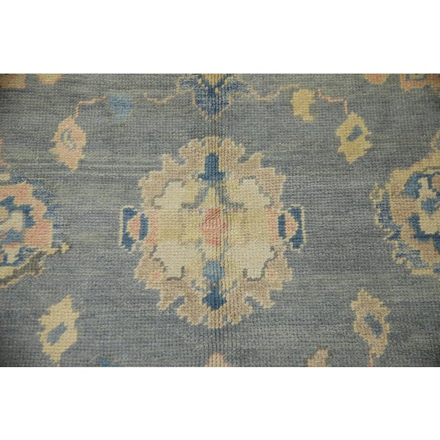 Enhance your living space with the timeless elegance of this Gray & Blue Handmade Turkish Oushak Rug, measuring 6'2" x...
