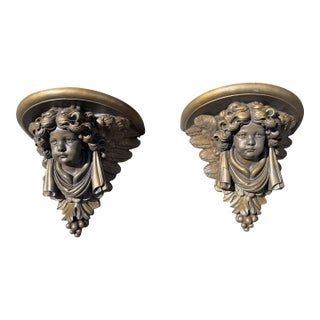 Pair of Figural Cast Resin Hanging Wall Shelves With Winged Cupid Angel Heads For Sale