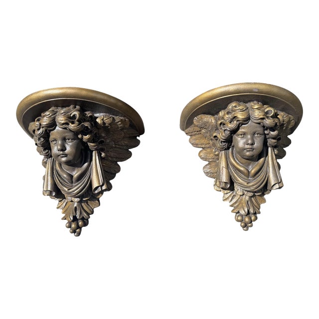 Pair of Figural Cast Resin Hanging Wall Shelves With Winged Cupid Angel Heads For Sale