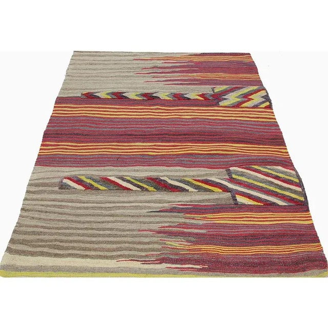 This bewitchingly beautiful example of a tribal Kilim area rug features a contemporary pop of electrifying bright colors...