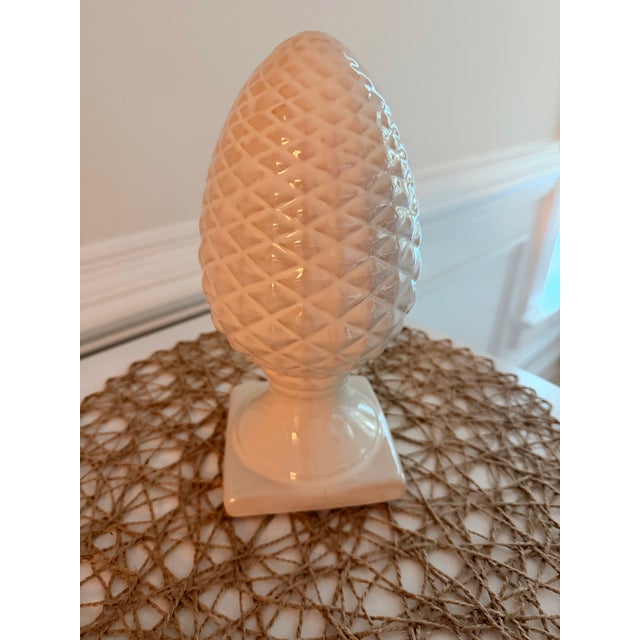 A beautifully sculpted ceramic pine cone finial featuring a crisp diamond pattern and elegant pedestal base. Finished in a...