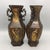 A striking pair of Chinese hexagonal bronze vases featuring extensive gold (gilt) detailing. Each vase has a faceted,...